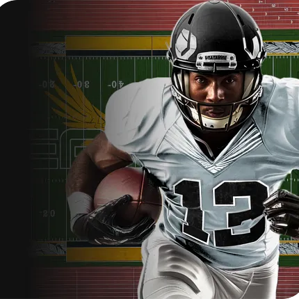 Football Player in Action Football player in black helmet and white jersey holding a football