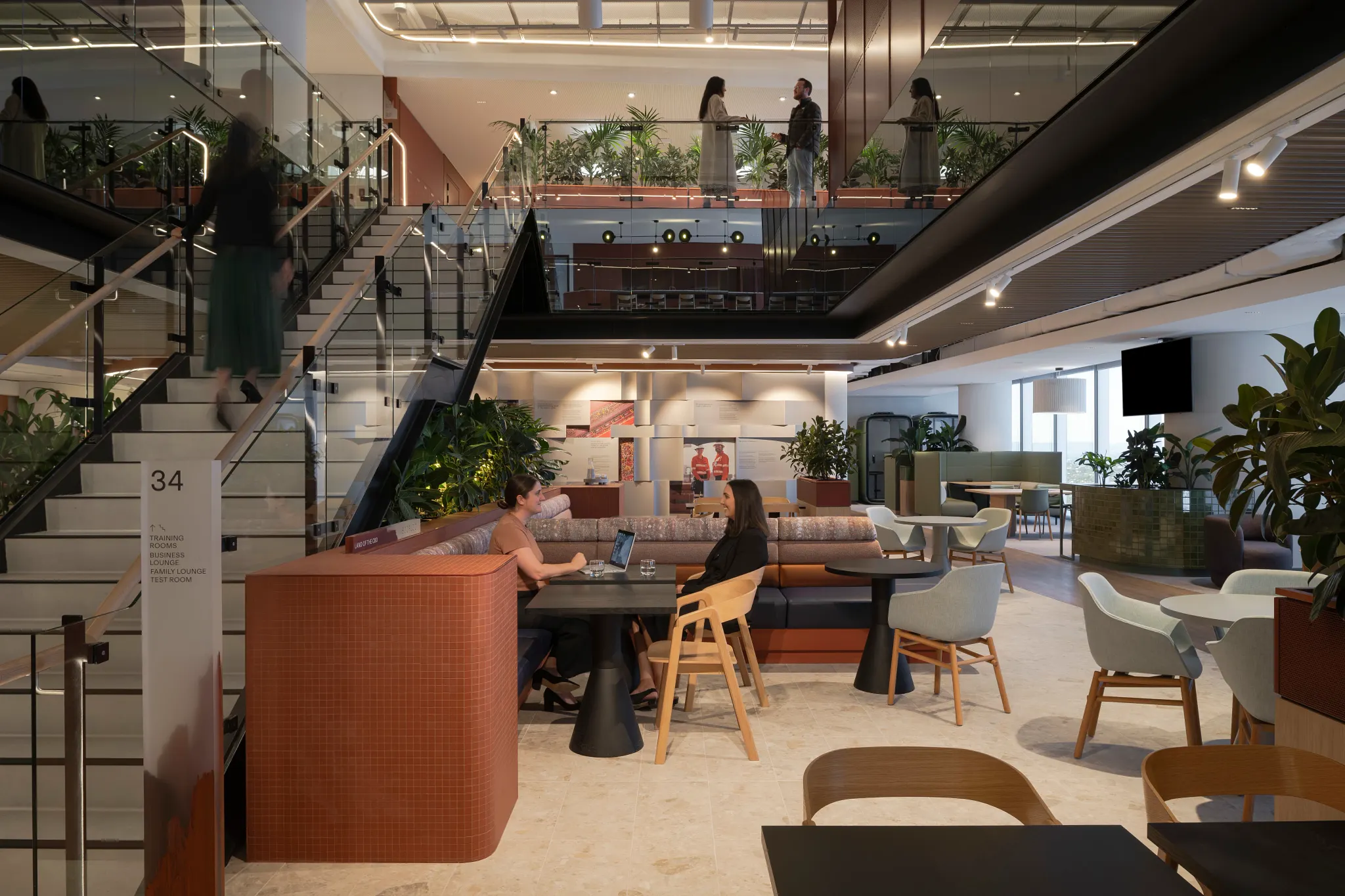 Modern office space with stylish seating and staircase