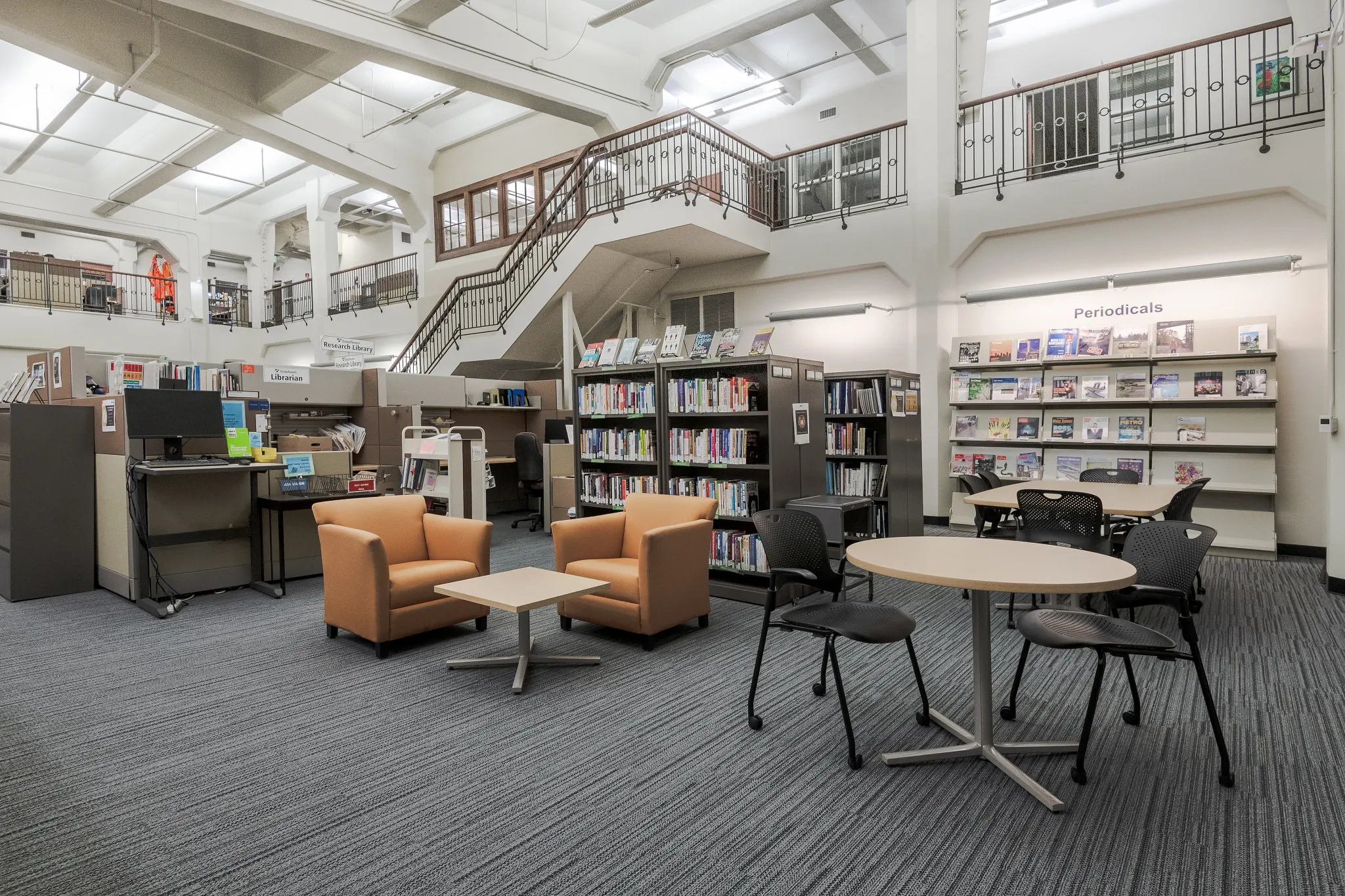 Media Center space with orange and black furniture with gray carpet tile