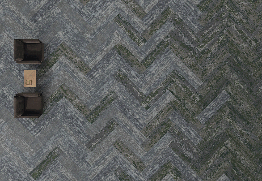 Herringbone Pattern Flooring with Brown Chairs and Table Herringbone pattern flooring in shades of gray and green with two brown chairs and a small table