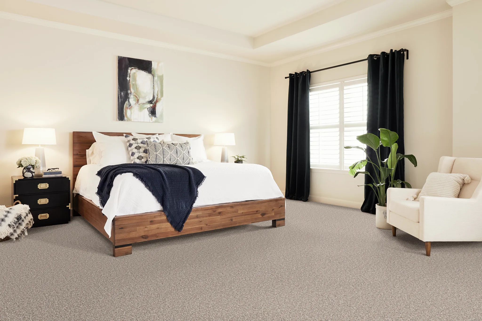 Cozy bedroom with beige carpet flooring, wooden bed, and modern decor
