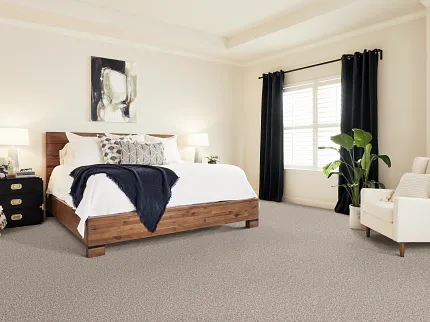 Comfortable and stylish bedroom with durable beige carpet flooring Cozy bedroom with beige carpet flooring, wooden bed, and modern decor