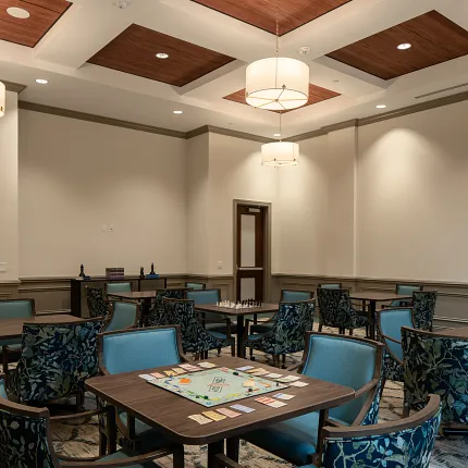 Stylish game room with sophisticated ceiling and carpet flooring Modern game room with elegant ceiling design and patterned carpet flooring