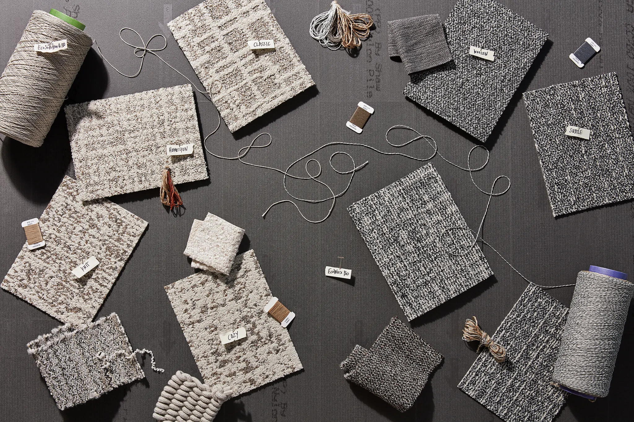 Assorted carpet swatches in neutral tones on display
