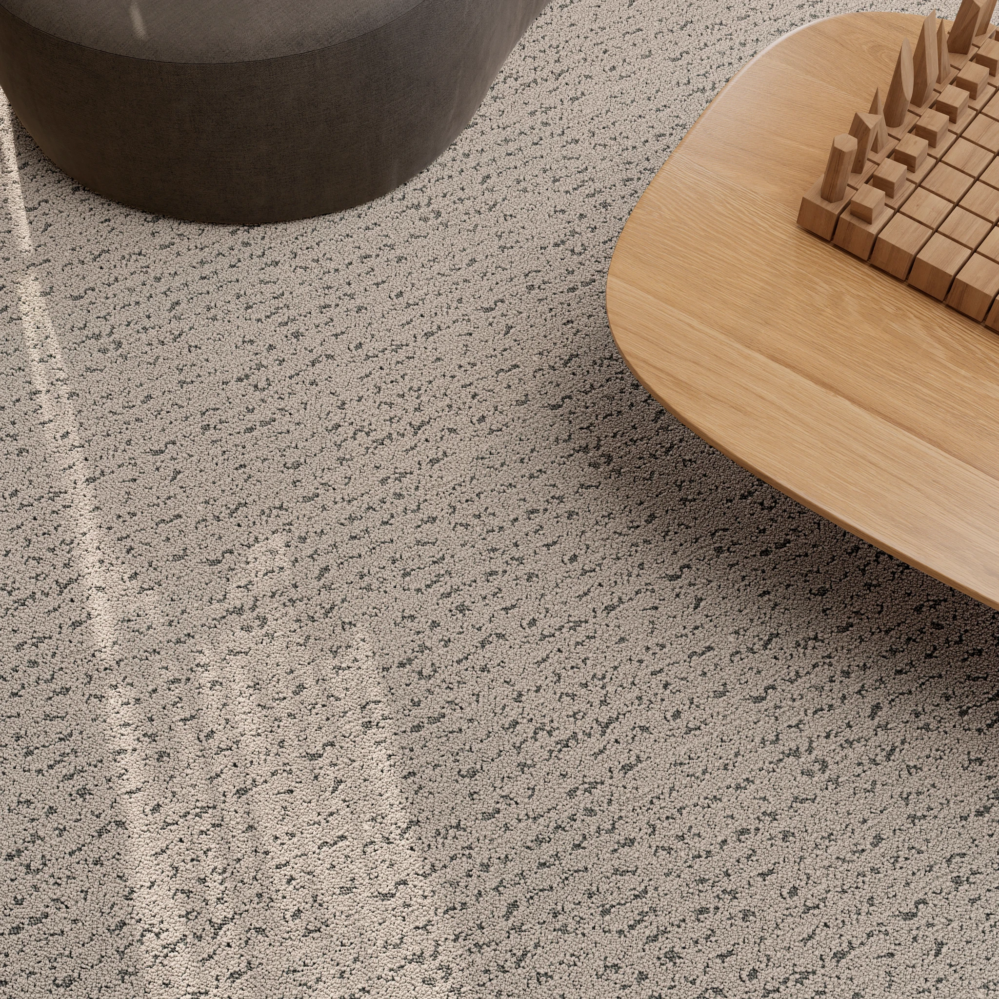 Close-up view of a textured broadloom carpet in a room with a gray and white speckled design
