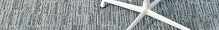 Stylish 18x36 inch carpet tile for contemporary interiors Modern carpet tile in blue and gray pattern with a chair and color swatches