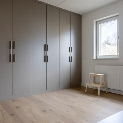 Light oak flooring in a modern minimalist room with grey cabinets