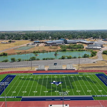 Sports field with artificial turf and running track aerial view. Aerial view of a sports field with artificial turf