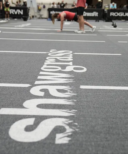 Durable gym flooring for active spaces Gym flooring with Shawgrass logo and people exercising