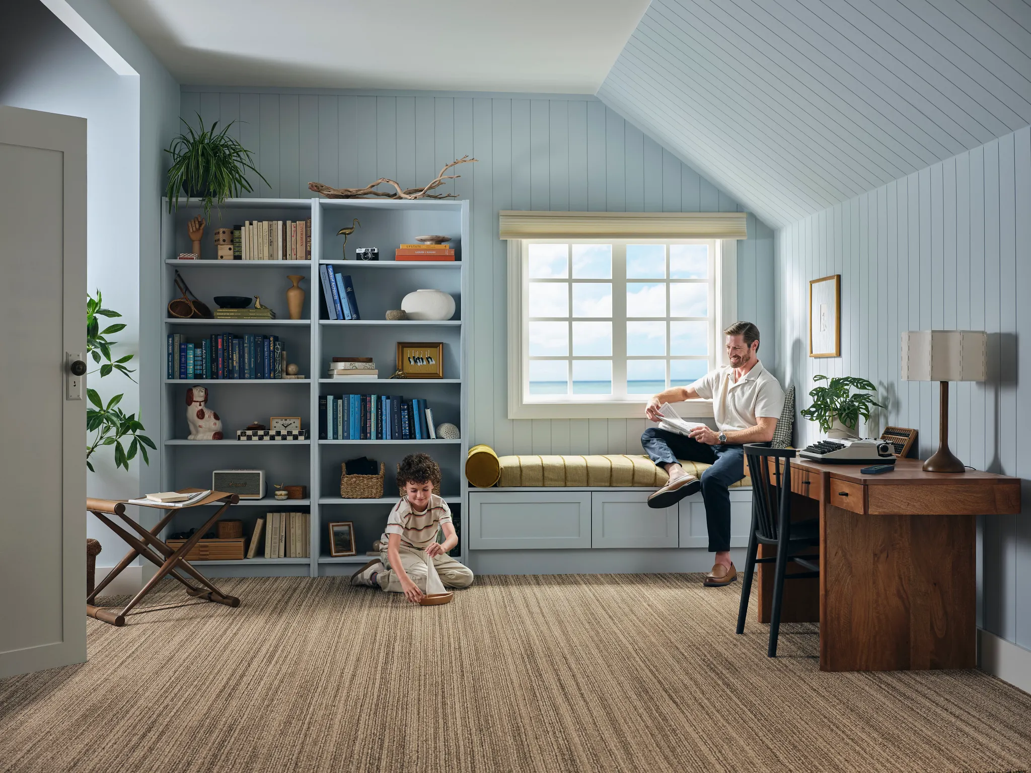Broadloom carpet in a cozy home office with bookshelves and window seat