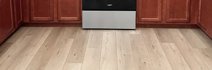 Light Wood Look LVP Flooring in Modern Kitchen Scene Modern kitchen with light wood look luxury vinyl plank flooring and cherry wood cabinets