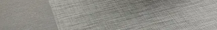 Commercial Woven Luxury Vinyl Tile in modern room with dark gray chair, 36x9 inch dimensions reThink in Hybrid and Pigment in Charcoal
