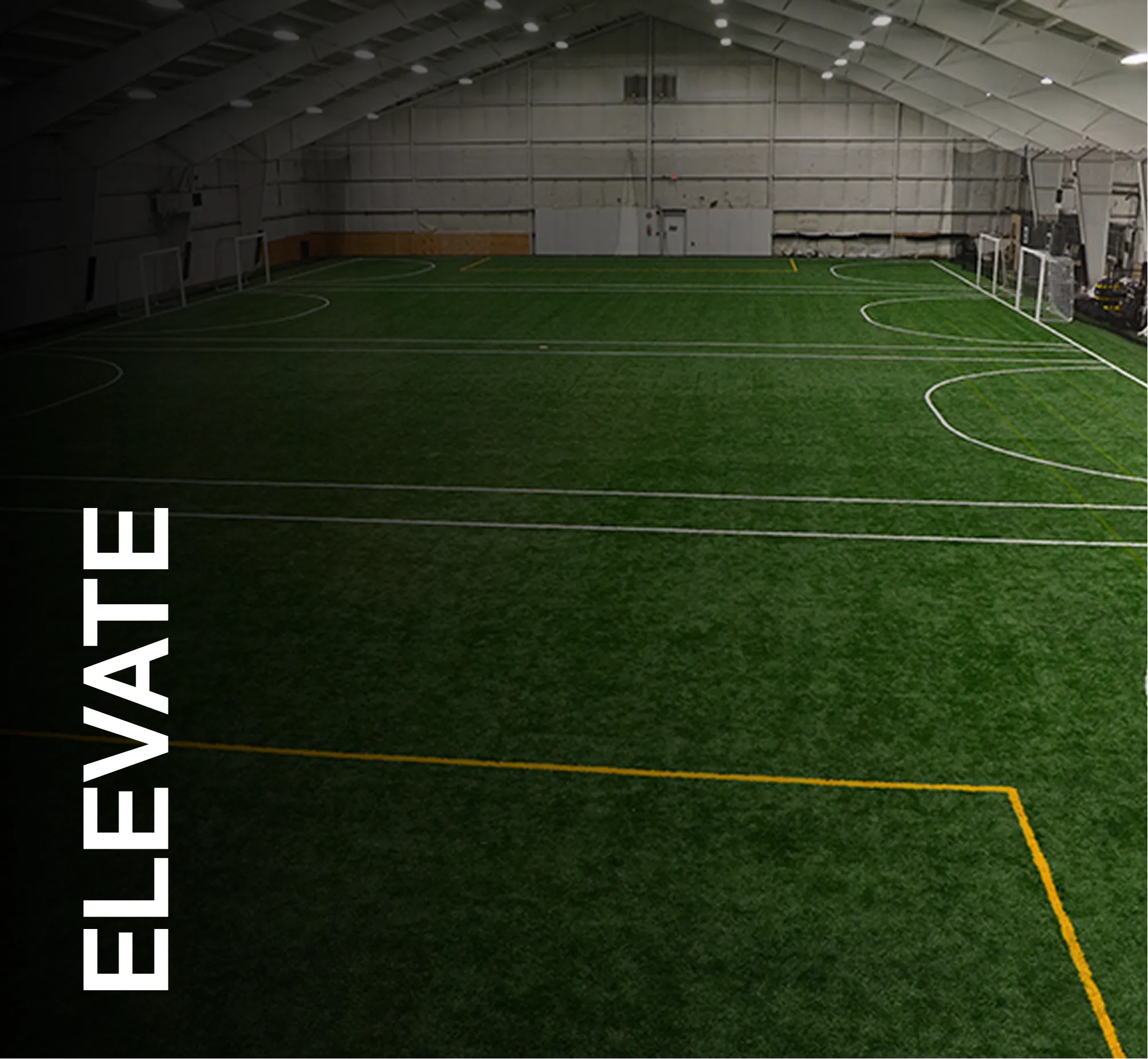 Indoor sports facility with artificial turf and soccer goals