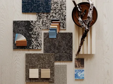 Commercial Carpet Tile Swatches on Light Wood Surface Assorted commercial carpet tile swatches in blue, gray, and brown tones on a light wood surface