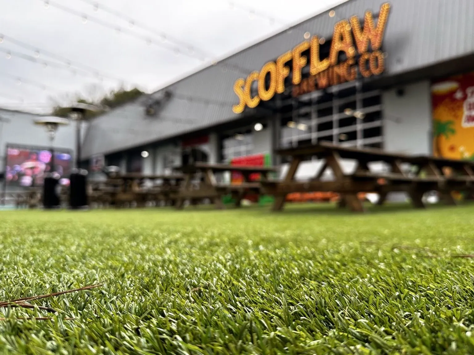 Artificial grass flooring outside a brewery