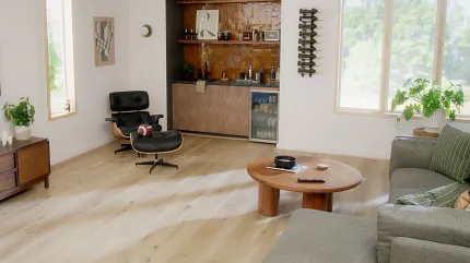 Light Wood Look Luxury Vinyl Plank Flooring in Modern Living Room Scene living room with light wood look luxury vinyl plank floor with a lounge chair coffee table and built-in bar area