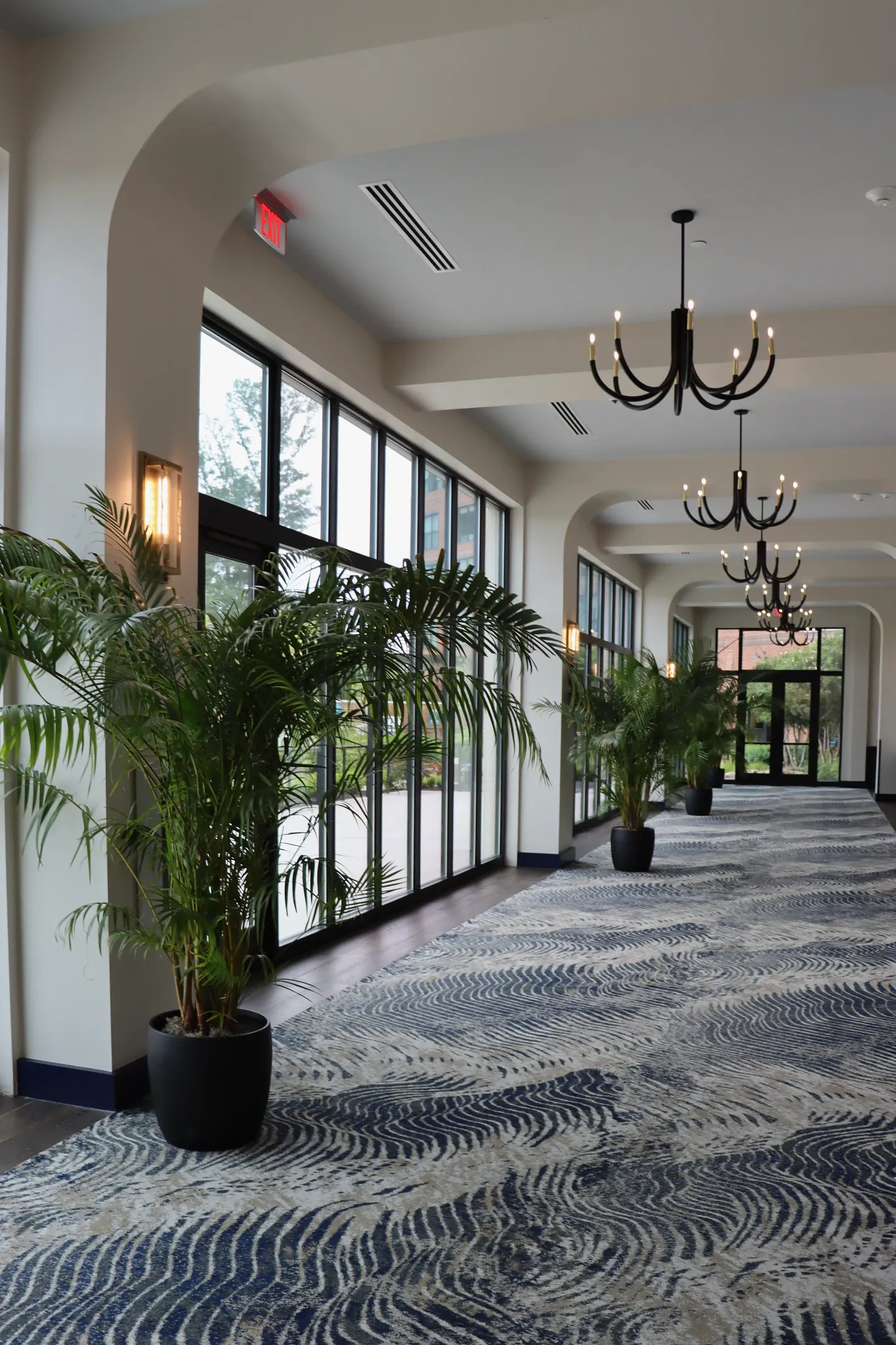 Hotel corridor with custom broadloom carpet and engineered hardwood flooring 