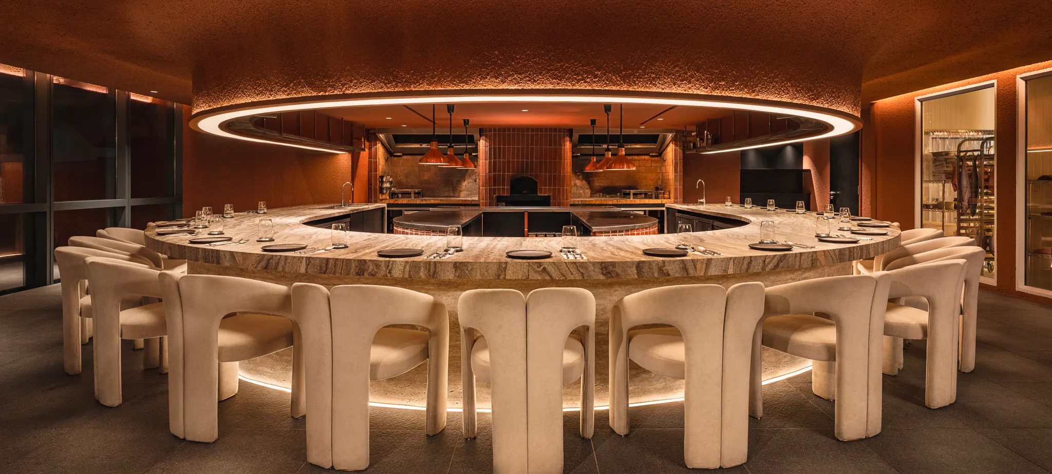 Elegant dining area with circular seating and ambient lighting on commercial flooring
