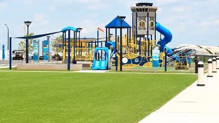 Vibrant playground with synthetic turf for safe play Playground with artificial grass and colorful equipment