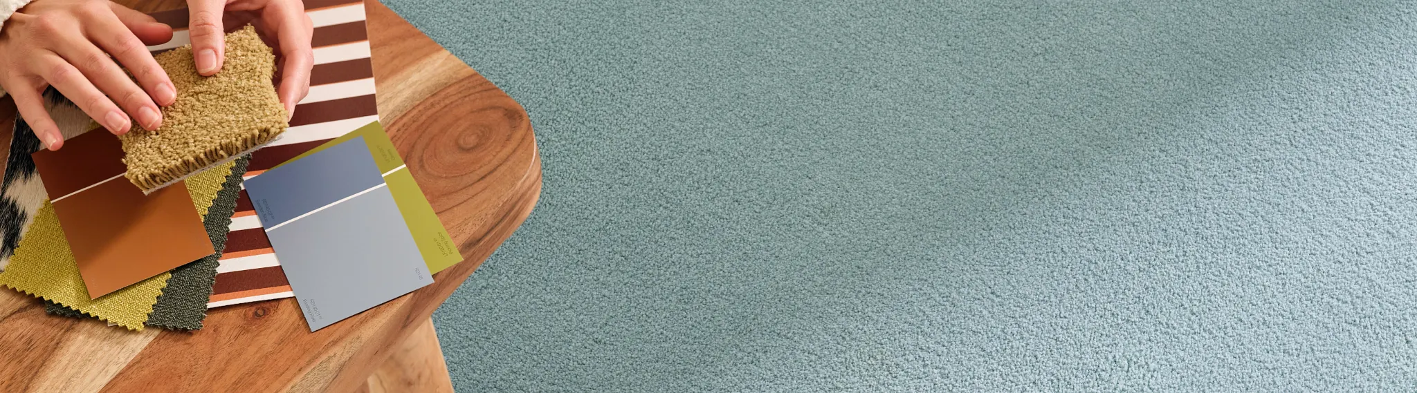 Carpet swatches in various colors on wooden table