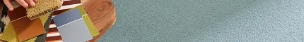 Light blue synthetic carpet with a wooden table and color swatches