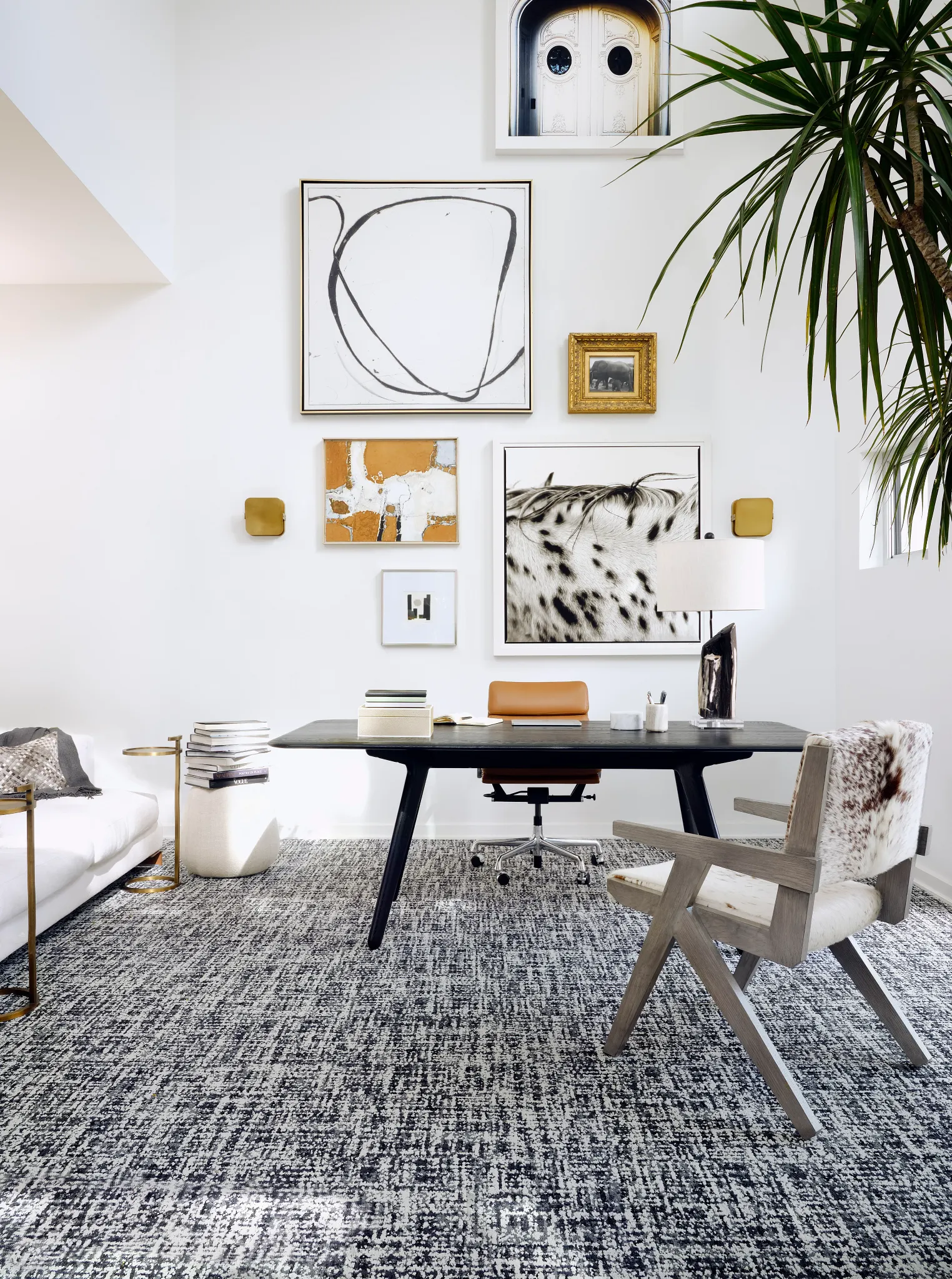 Modern office space with abstract wall art and a textured grey and white carpet
