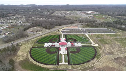 Sports complex with artificial turf baseball fields aerial view. Aerial view of a sports complex featuring multiple baseball fields with artificial turf