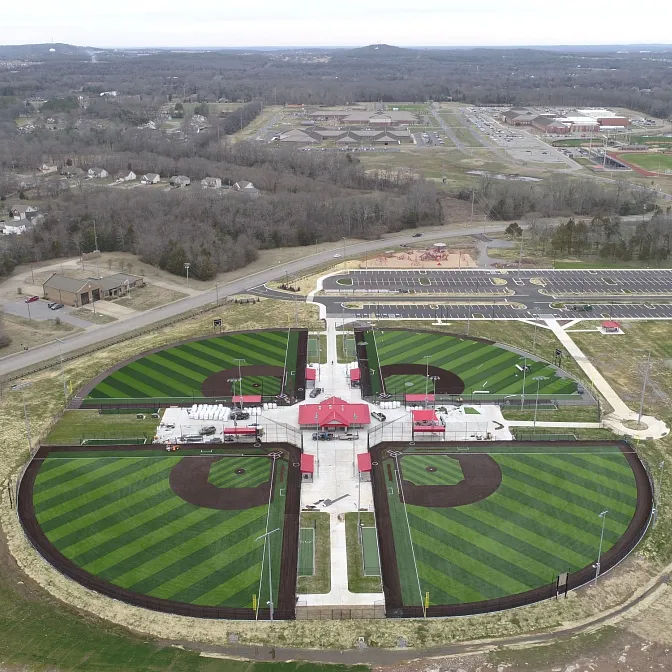 Sports complex with artificial turf baseball fields aerial view. Aerial view of a sports complex featuring multiple baseball fields with artificial turf