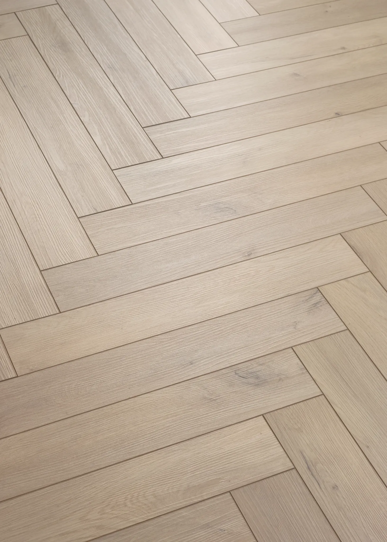 Herringbone pattern luxury vinyl plank flooring in light oak color