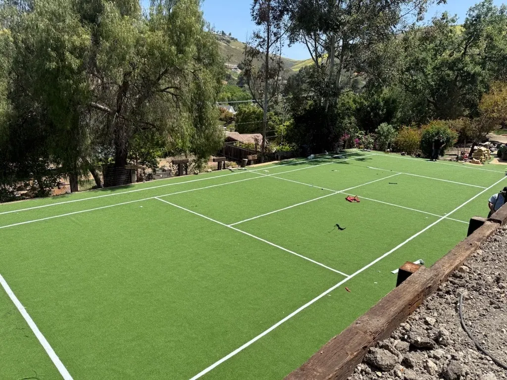Outdoor tennis court with green artificial turf