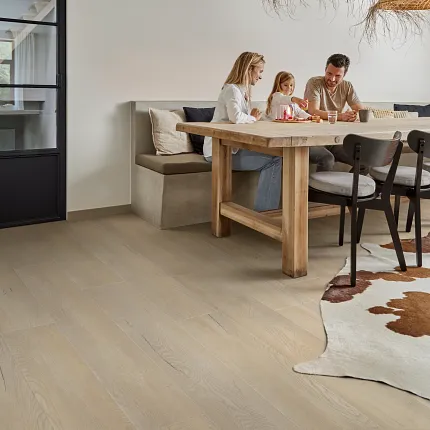 Wood Look Luxury Vinyl Plank Flooring in Modern Dining Room Scene dining room with wood look luxury vinyl plank floor featuring a family dining at a wooden table under woven pendant lights