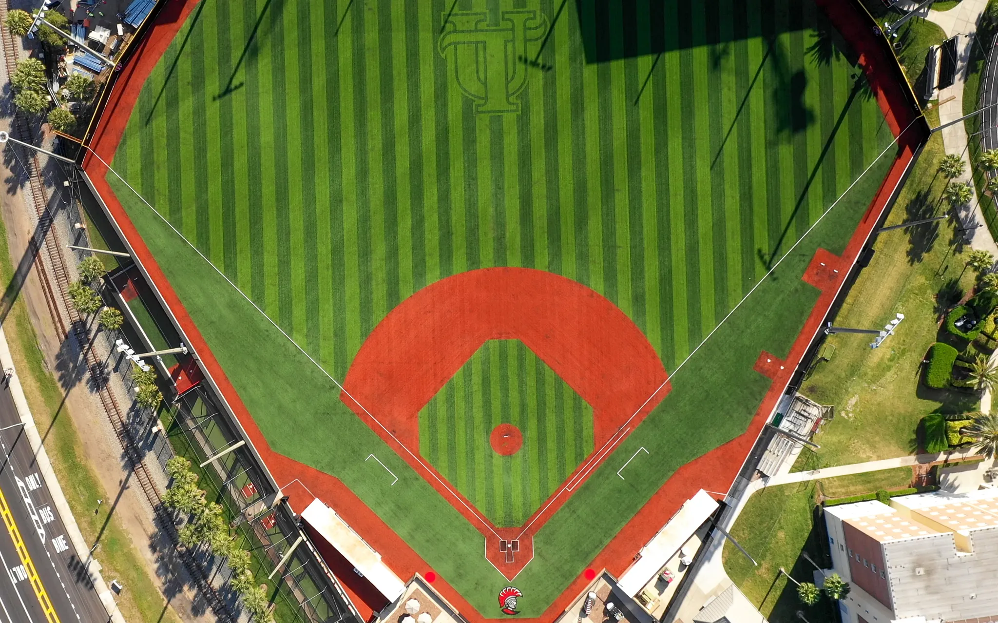 Aerial view of a baseball field with artificial turf and red clay areas