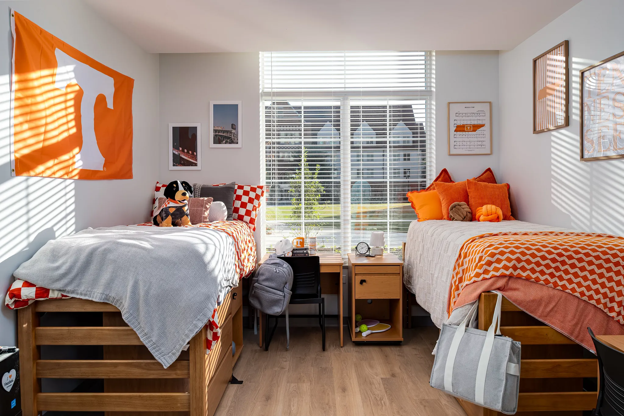 Cozy dorm room with wooden flooring and twin beds