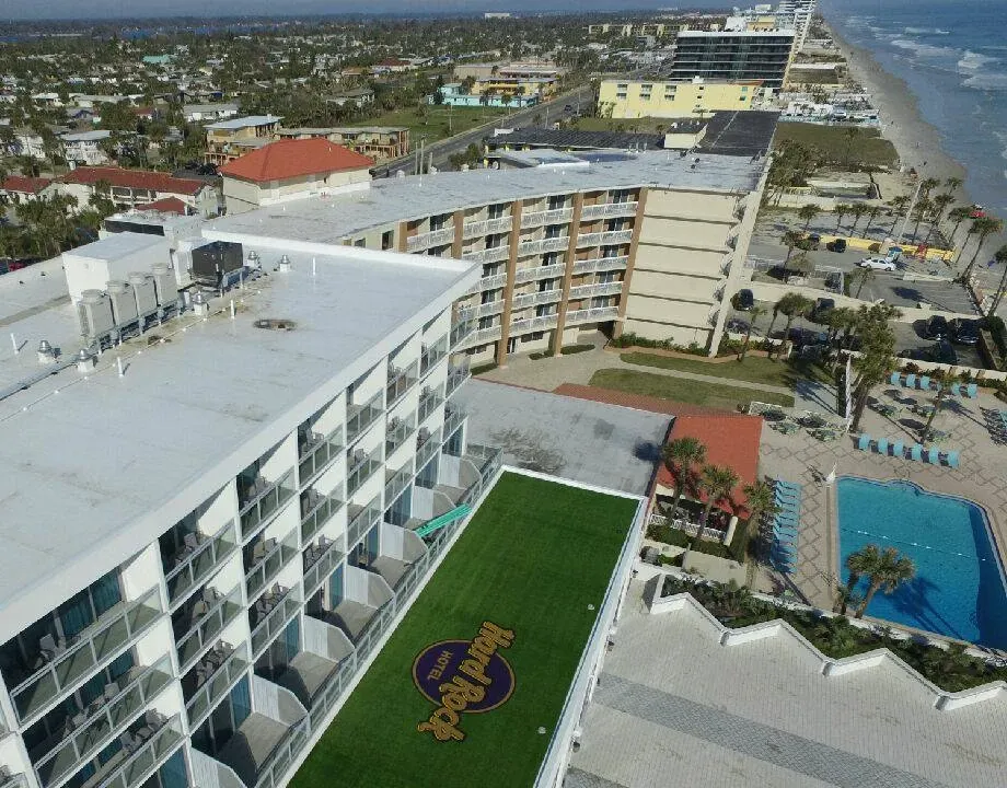 Aerial view of beachfront hotel with rooftop logo