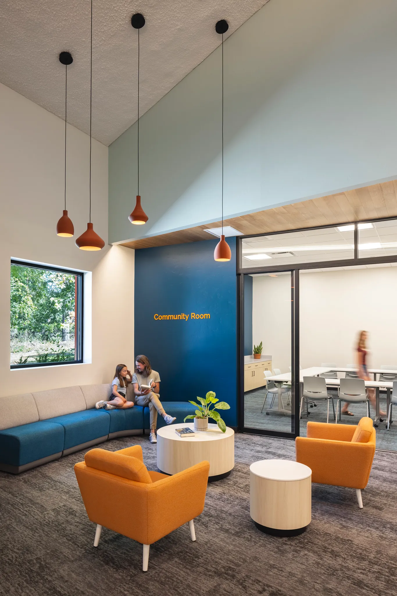 Community room with modern seating and commercial carpet tile flooring in an education facility
