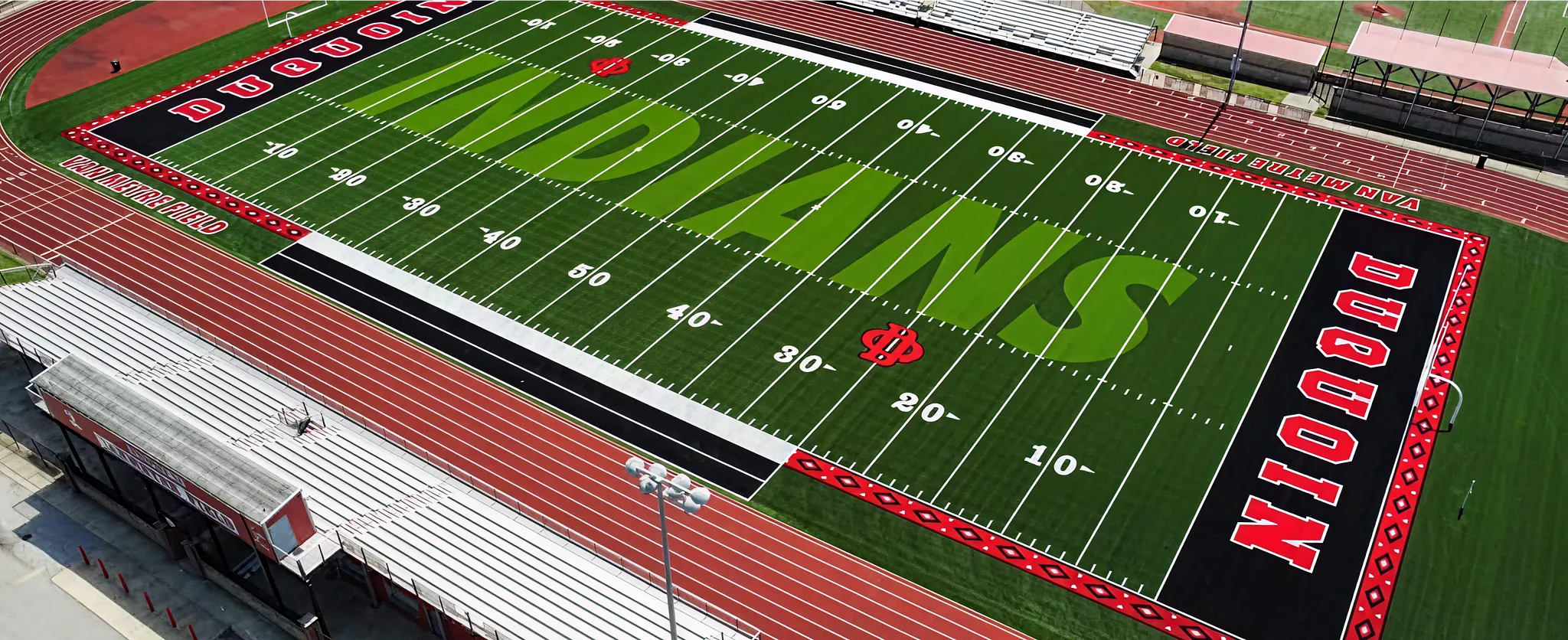 Aerial view of a football field with artificial turf