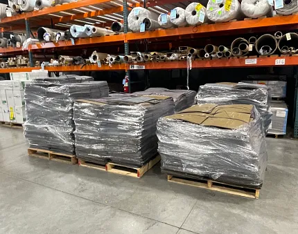 Durable commercial carpet tiles for versatile applications Stacks of commercial carpet tiles in warehouse