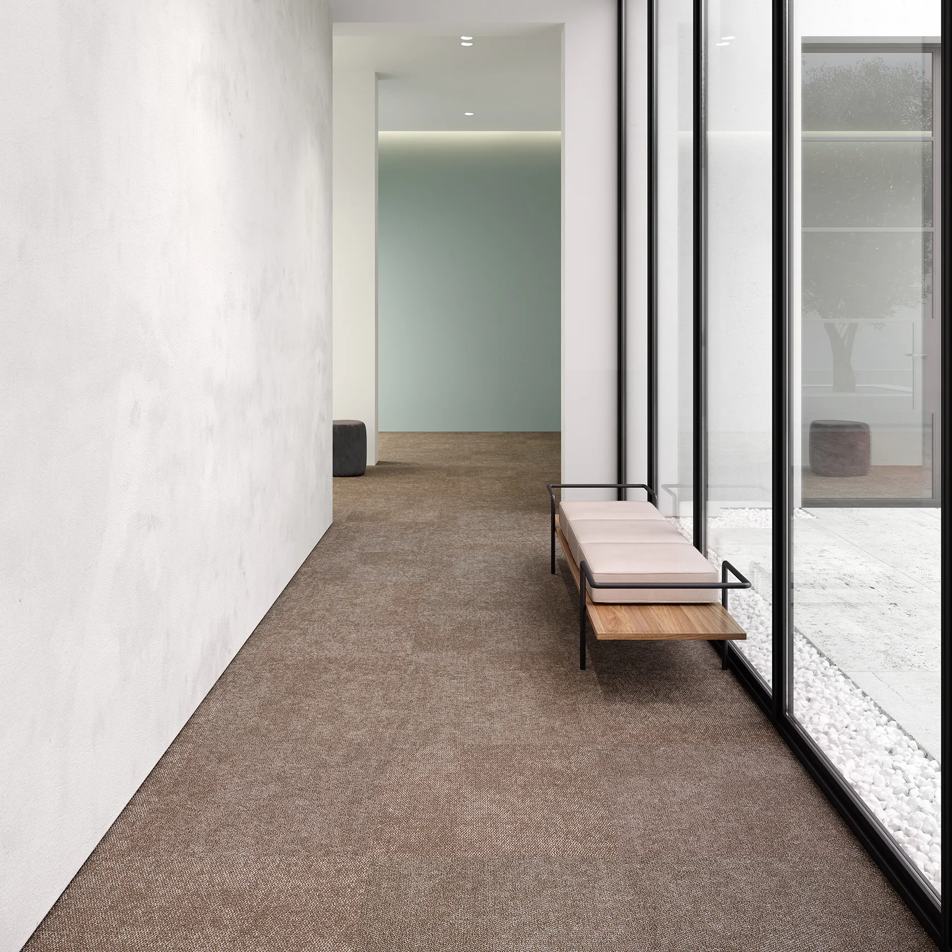 Modern hallway with brown commercial carpet tile flooring and a minimalist bench