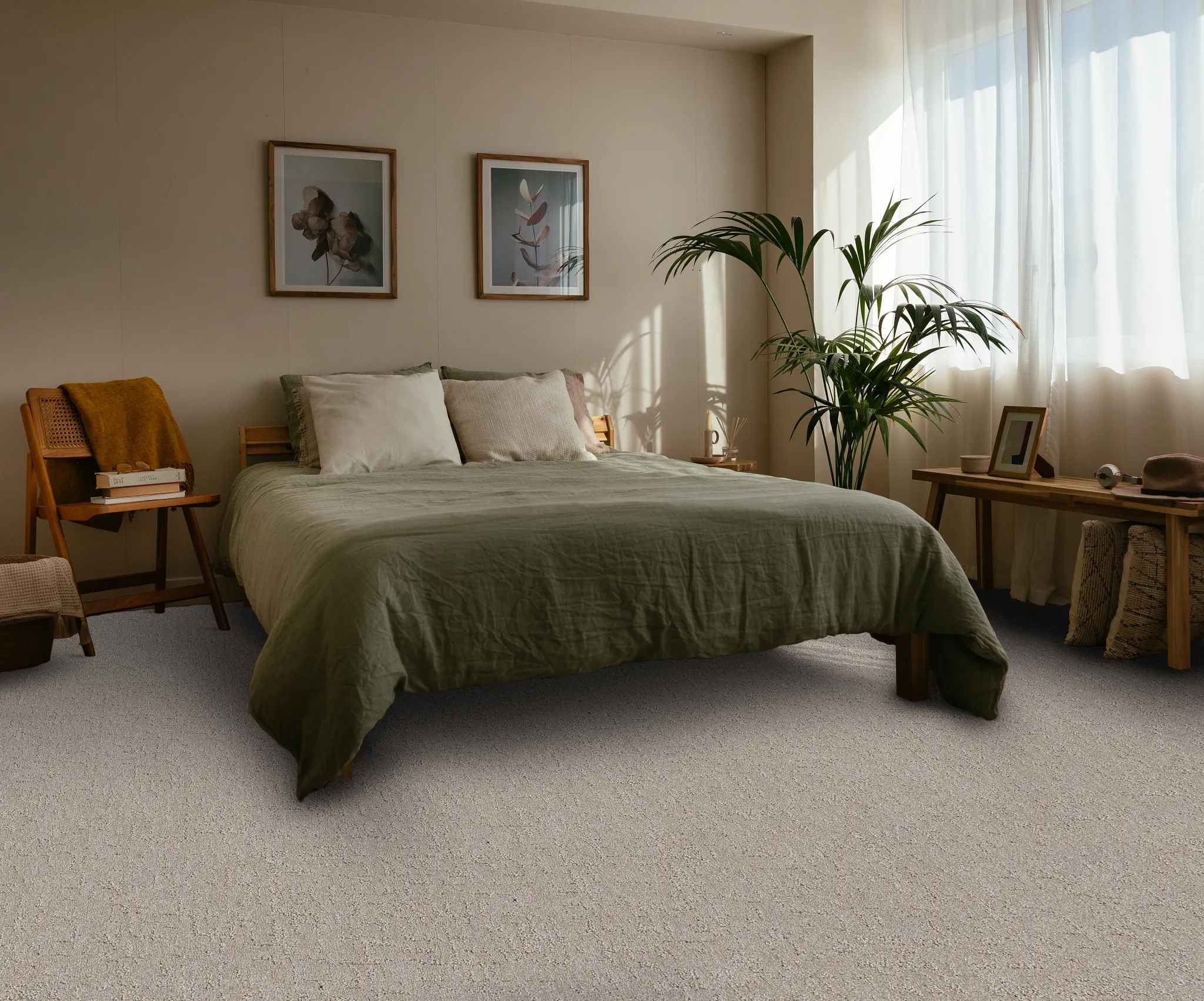 Cozy living room with textured carpet flooring, featuring a cream armchair, wooden side table, and a green plant