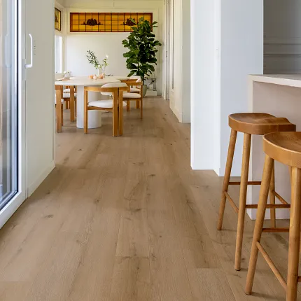 Luxury Vinyl Plank Flooring in Modern Living Room with Wood Look Design living room with luxury vinyl plank floor in a wood look design with a stylish black chair and artwork on white brick walls