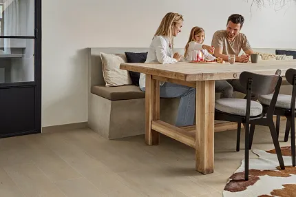 Light Wood Look Luxury Vinyl Plank Flooring in a Modern Dining Room Scene Modern dining room with light wood look luxury vinyl plank flooring and a family gathered around a wooden table