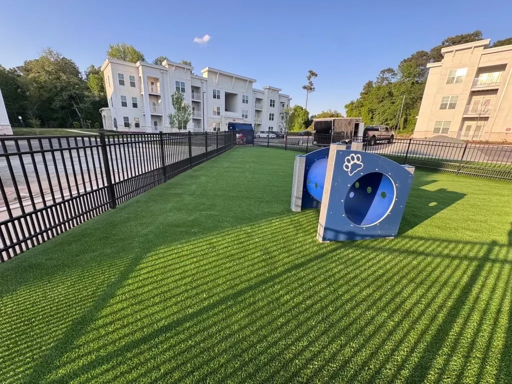 Artificial grass in a playground with modern apartment buildings