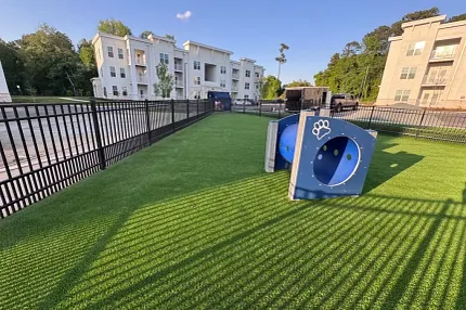 Durable artificial turf for outdoor play areas Artificial grass in a playground with modern apartment buildings
