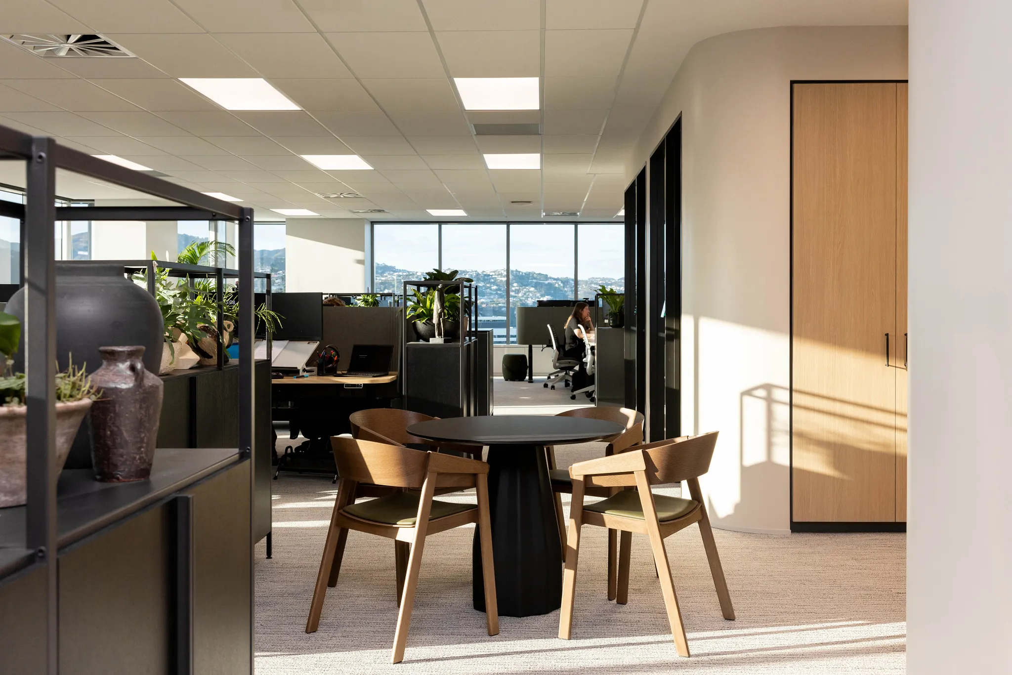 Modern office space with carpet flooring and wooden furniture