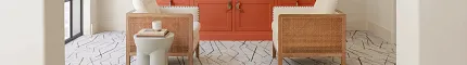 Contemporary living room with stylish geometric flooring and vibrant decor Modern living room with geometric patterned flooring, orange cabinetry, and wicker chairs
