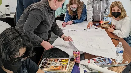 Creative team working on architectural project in contemporary office setting Group of people collaborating on design plans in a modern workspace