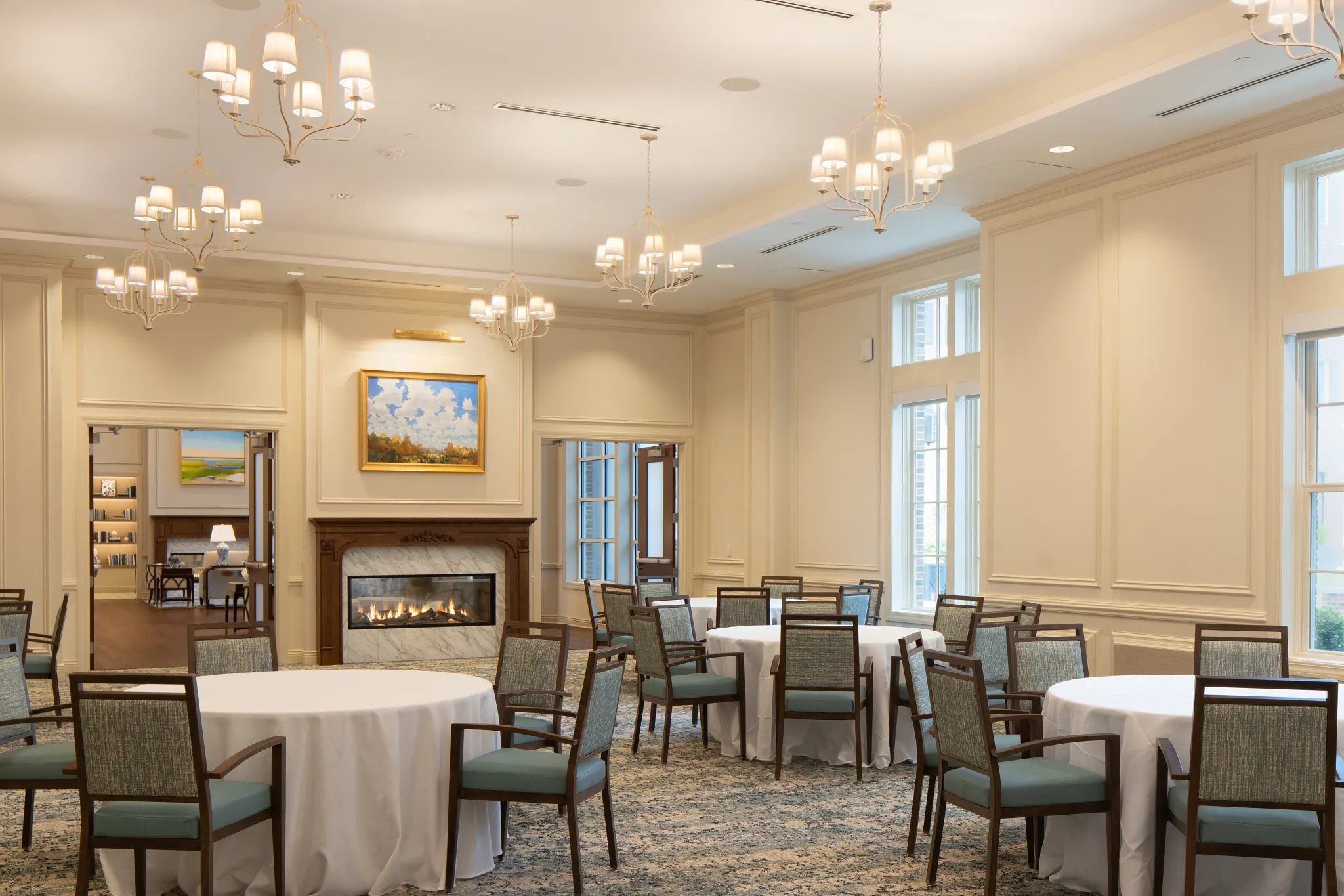Elegant dining room with carpet flooring and chandeliers