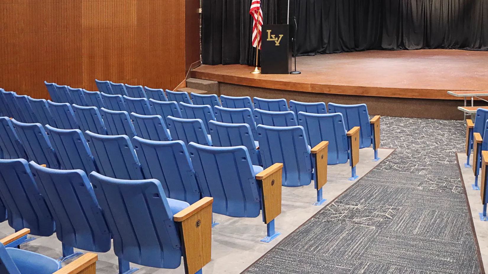 High school auditorium with grey carpet tile