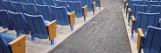 Durable carpet flooring for educational auditoriums Auditorium with blue seating and carpet flooring in an education facility