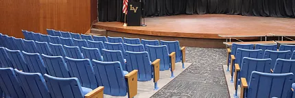 Durable carpet flooring for educational auditoriums Auditorium with blue seating and carpet flooring in an education facility